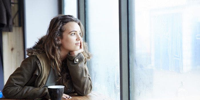 Late teens girl looking out of window